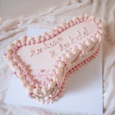 a cake shaped like a heart on top of a card