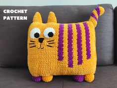 a crochet cat pillow sitting on top of a couch with the words crochet pattern written across it