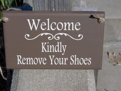 a sign that says, welcome kindly remove your shoes