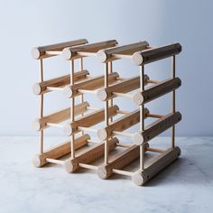 a wooden wine rack sitting on top of a marble counter