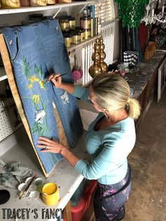 a woman is working on an art piece in her studio with the words tracey's fancy