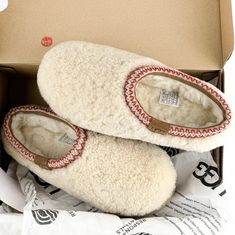 a pair of white slippers in a box