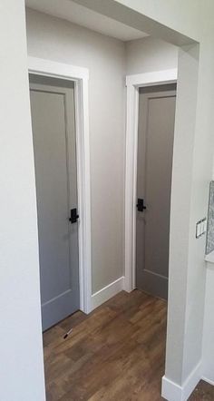 an empty room with white walls and wooden floors