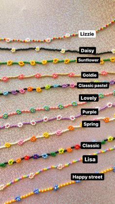 a bunch of beads that are sitting on the floor with words written in each one