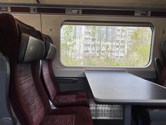 an empty table and chairs in a train car