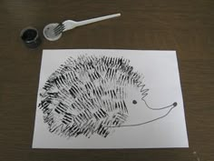 a drawing of a hedgehog next to a knife and fork on a table top