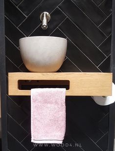 a white bowl sitting on top of a wooden shelf