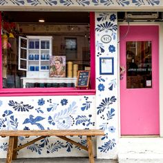 a bench in front of a painted shop