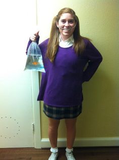 a woman in purple shirt and plaid skirt holding up a plastic bag