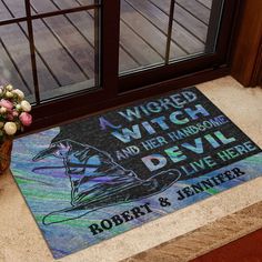 a door mat with the words wizard and her handsome devil on it next to a potted plant