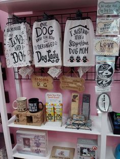 there are many items on the shelves in this store that include mugs, books and other things