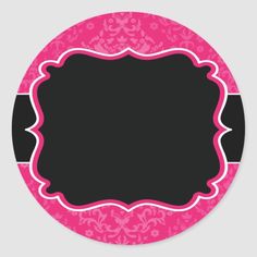 a pink and black round sticker with an ornate frame in the center on a white background