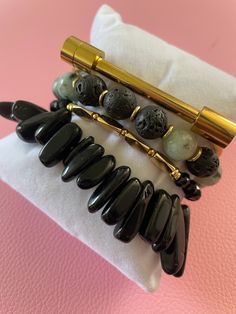 Gemstone Significance: Black Obsidian: Known for its grounding and protective properties, black obsidian helps to shield against negativity and promote emotional balance. Dalmatian Jasper: This unique stone is believed to bring a sense of playfulness and joy, encouraging a positive outlook and a sense of harmony. Versatile Style: The Obsidian & Jasper Bracelet Set is perfect for adding a touch of elegance and sophistication to any outfit. Whether you're dressing up for a special event, adding flair to your everyday look, or seeking a meaningful gift, these bracelets are a versatile and stylish choice. Description: Enhance your jewelry collection with the Obsidian & Jasper Bracelet Set. Handcrafted by skilled artisans, this set features four stunning bracelets made with black obsidian and d Elegant Obsidian Bracelets For Meditation, Modern Black Bracelets With 8mm Beads, Modern Black Bracelet With 8mm Beads, Modern Black Round Bead Bracelets, Minimalist Black Onyx Beaded Bracelets, Black Lava Stone Beaded Bracelets, Hand-strung, Hand-strung Black Lava Stone Beaded Bracelets, Black Hand-strung Lava Stone Beaded Bracelets, Black Lava Stone Beaded Bracelets With Natural Stones