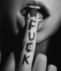 a black and white photo of a woman holding a pencil with the word luck written on it