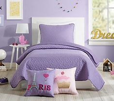 a bedroom with purple walls and bedding in the middle is decorated with pink decorations