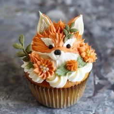 a cupcake with frosting and flowers on it