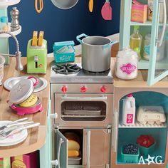 a toy kitchen with an oven, stove and sink