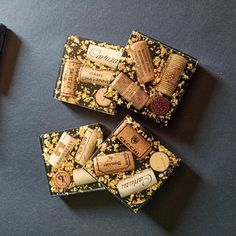 three wine corks sitting on top of a black table next to a bottle opener