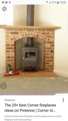 an old brick fireplace with a wood burning stove