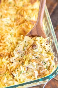 chicken rice casserole in a glass dish with a wooden spoon on the side