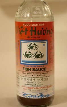 a bottle of fish sauce sitting on top of a table