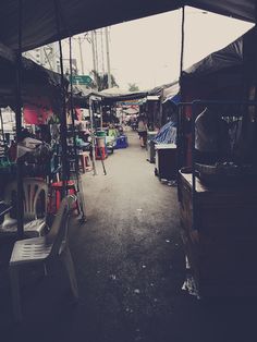 an outdoor market with lots of tables and chairs