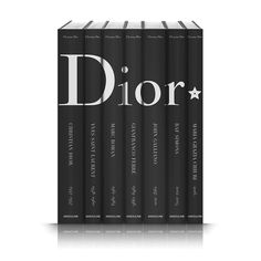 a set of four black books with the word dior written on them in white