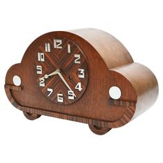 a wooden clock that is shaped like a cloud