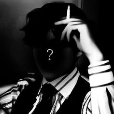 black and white photograph of a person wearing a suit with a question mark on his face