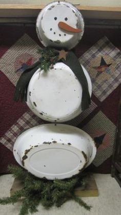 three snowmen made out of old dishes