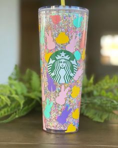 the starbucks cup has been decorated with glitter and hand prints