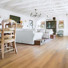 a living room filled with furniture and a wooden floor