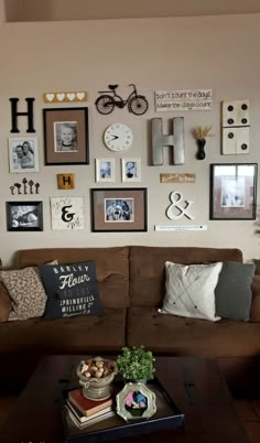 a living room filled with furniture and lots of pictures on the wall above it's coffee table