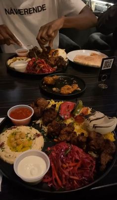 a man sitting at a table full of food