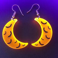 Pictures don't do these justice. These fluorescent bat-moon earrings glow under black light, but also add an amazing pop of color in regular light. 1.25in long 0.5in wide Stainless steel earring hooks Quirky Cheap Halloween Jewelry, Black Glow In The Dark Party Jewelry, Alice In Wonderland Tim Burton, Giant Spider Web, Vampire Skeleton, Halloween Victorian, Halloween Tights, Pop Tab Crafts, Weird Earrings