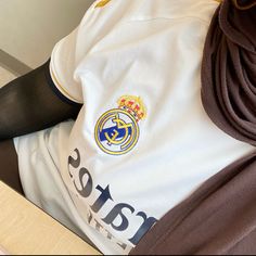 there is a soccer jersey with the real madrid crest on it and black tights