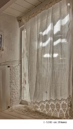 an old bathroom with white walls and curtains