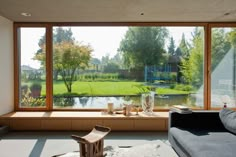 a living room filled with furniture and large windows