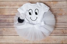 a white tutu with a smiley face drawn on it