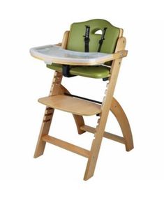 a wooden high chair with a green seat