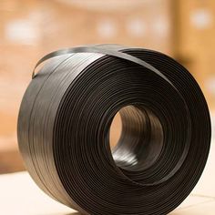 a roll of black plastic tape sitting on top of a table