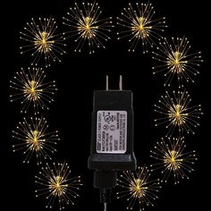 a power cord is plugged into a charger with fireworks in the back ground