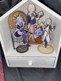 a wooden box with some paper cut outs on it