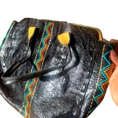 Rare Colleen Cordero Beautiful Black Leather Tote With Stuffing And Orange And Teal Aztec Decoration. Perfect Large Size For Travel Or Everyday Use. See Photos For Measurements. 17 Inches Across 13 Inches From Top To Bottom. Rare Style, No Longer Available. Brand New Condition, Spotless Inside And Out, Never Used. See Photos. Hand-stitched Multicolor Leather Bags, Bohemian Black Shoulder Bag With Leather Handles, Black Bohemian Shoulder Bag With Leather Handles, Bohemian Black Satchel For Everyday Use, Black Shoulder Bag With Removable Pouch For Festival, Designer Multicolor Leather Shoulder Bag, Designer Multicolor Leather Satchel, Handmade Black Satchel For Shopping, Artisan Black Shoulder Bag