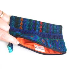 Looking for the perfect ZERO WASTE accessory? Then this little Pouch (and it's slightly smaller, sister Lunita) is what you've been looking for. This darling clutch sized Travel pouch is perfect for keeping your things in order when you travel near and far. Its bold textile print comes from re-purposed traditional hand-woven huipiles, the indigenous clothes of local Maya women. Instead of throwing out these leftover scraps from past projects, we preserve their integrity and give them a second li Travel Wallets With Zipper Pouch, Travel Wallet With Zipper Pouch, Blue Travel Pouch Coin Purse, Multicolor Coin Purse With Removable Pouch For Travel, Handmade Blue Coin Purse For Travel, Handmade Travel Coin Purse, Travel Coin Purse Clutch, Travel Clutch Coin Purse, Multicolor Travel Coin Purse Clutch