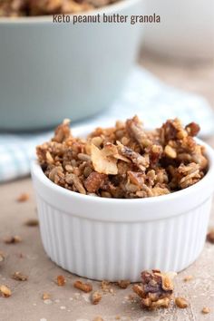 a bowl filled with granola sitting on top of a table