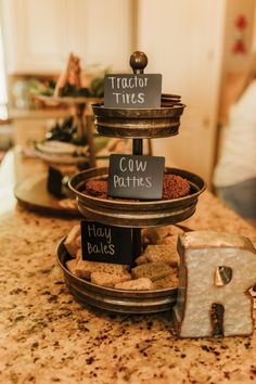 three tiered trays filled with cookies on top of a counter next to each other