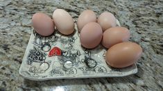 six eggs sitting on top of an egg tray