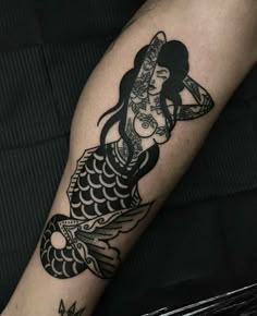 a woman's arm with a tattoo on it and a fish in the middle