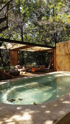 an outdoor swimming pool surrounded by trees